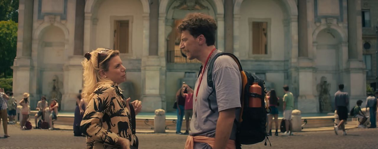 Fontana dell'Acqua Paola seen in the background as Mattia converses with a random lady. (Image via youtube.com/Netflix)